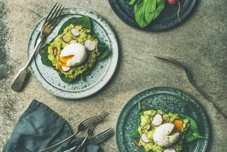 Healthy vegetarian wholegrain avocado toasts with poached egg, square crop
