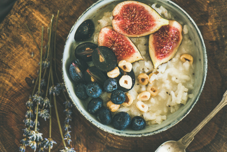 Rice coconut porridge with figs, berries and hazelnuts, square crop