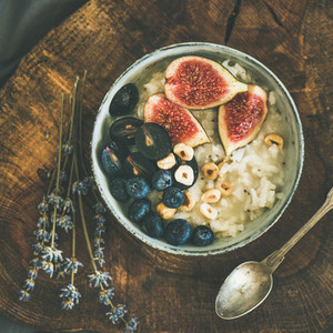 Rice coconut porridge with figs  berries and hazelnuts  square crop