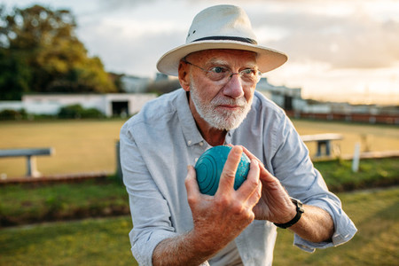 Elderly man playing a game of boules