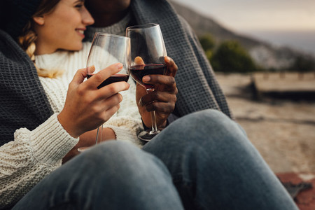 Loving couple with wine on a winter day picnic