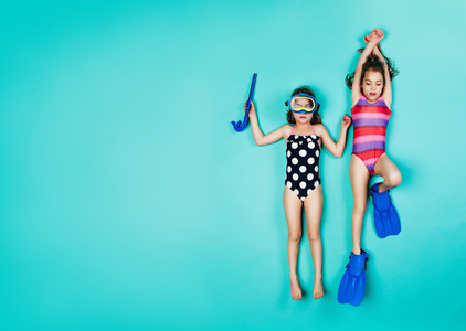 Twin girls pretending to be snorkelling