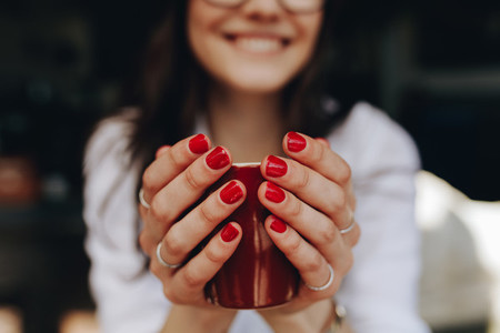 Woman hands holding a coffee cup