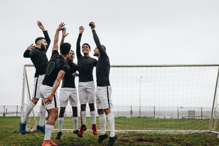 Soccer players jumping in place after a pep talk