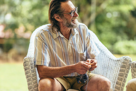 Retired man relaxing on armchair
