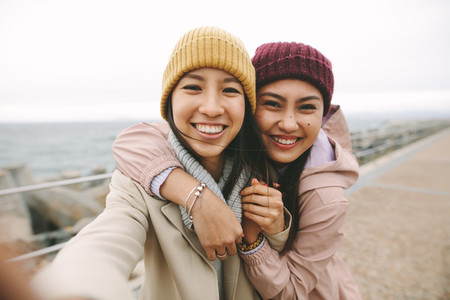 Close up of two asian women standing together outdoors