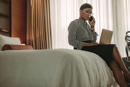 Businesswoman on tour working from hotel room