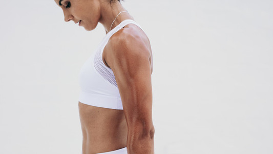 Close up of an athletic woman standing during workout