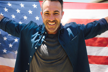 Portrait of a man holding american flag