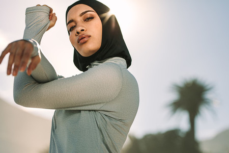 Muslim female exercising outdoors in morning