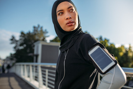 Hijab girl taking a break after workout in city