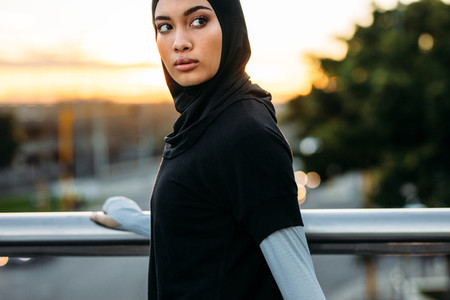 Fitness woman in hijab standing outdoors in morning