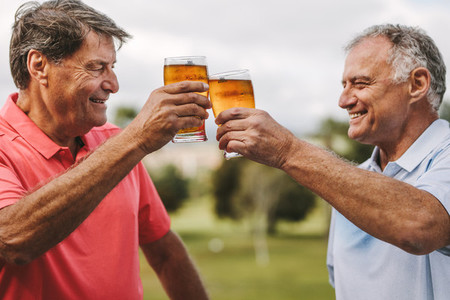Senior men celebrating with beers