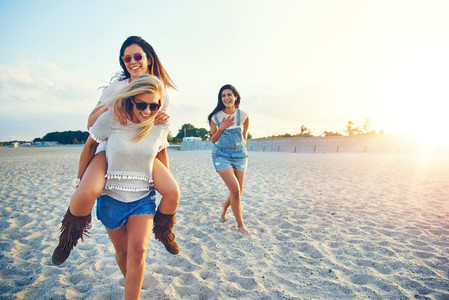 Three girls spending time on beach together