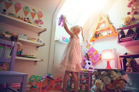 Little kid playing with toy in bedroom
