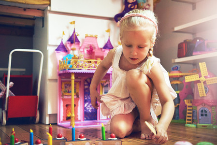 Cute little girl with sliced toy cake
