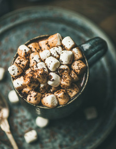 Winter warming hot chocolate with marshmallows in mug