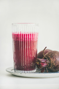 Fresh morning detox beetroot smoothie in glass white background