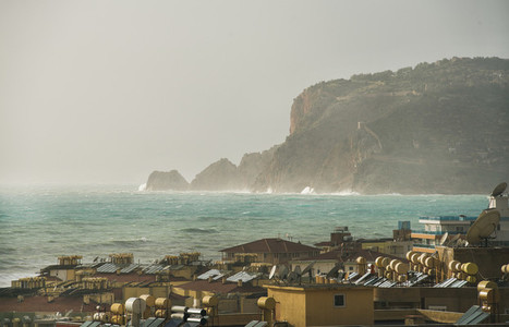 View over the stormy sea and castle hill of Alanya
