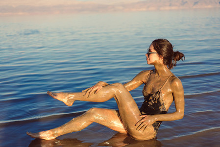 A young woman enjoying the natural mineral mud