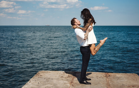 Guy and girl on the sea pier