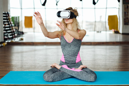 Woman in yoga class with VR headset