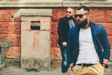 Two stylish bearded men on the background of each other