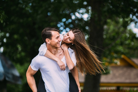 Young adult brunette man and woman in the park