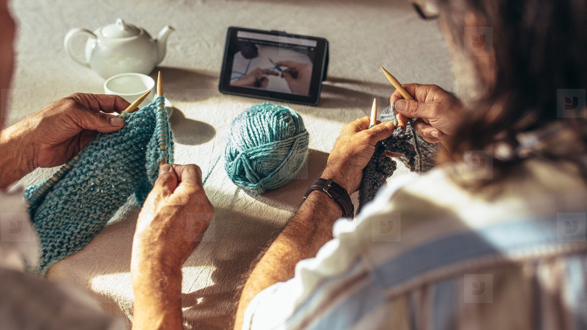 Retired people learning knitting from online videos