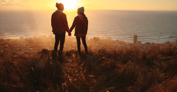 Romantic couple on peak at sunset