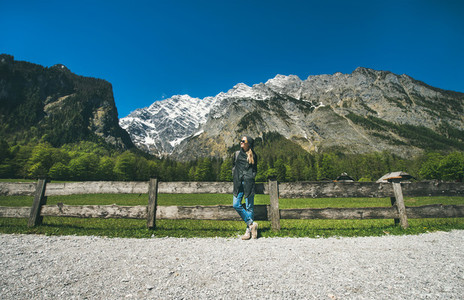 Female traveller posing in front of mountain view of Alps