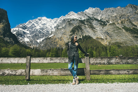 Female traveller posing in front of mountain view of Alps