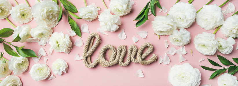 Saint Valentines Day background with ranunculus flowers and word love