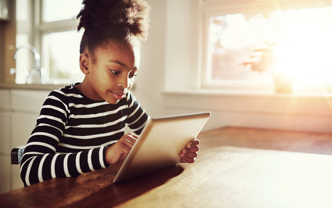Young black girl browsing on a tablet pc
