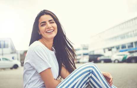 Smiling woman with striped pants turns to camera
