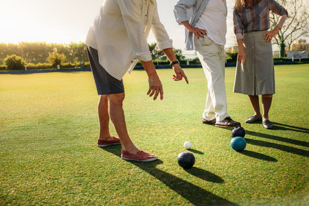 Group of people playing boules in a lawn