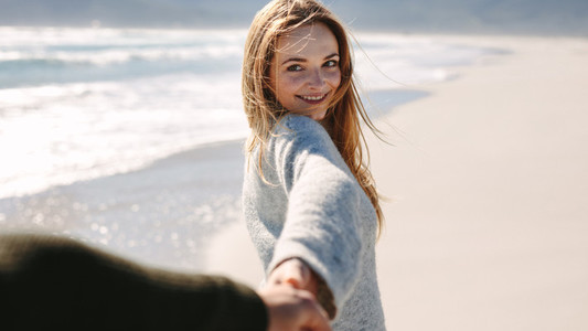 Woman taking a beach walk with her boyfriend
