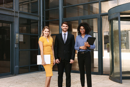 Businessman with female colleagues in corporate office building