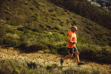 Senior man trail running