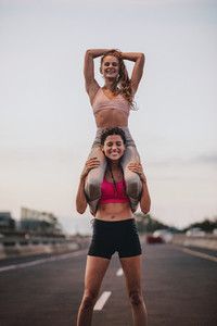 Women doing partner workout outdoors