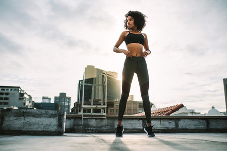 Athletic woman doing fitness training on rooftop