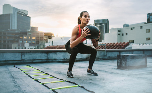 Fitness woman doing exercises on rooftop