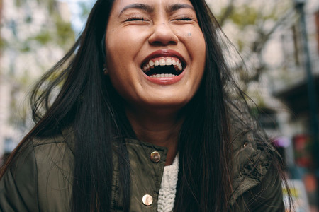 Close up of an asian woman laughing