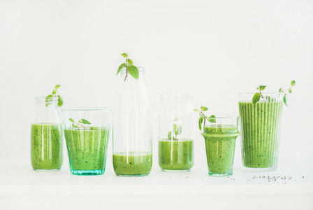 Fresh morning matcha green smoothie or juice in glasses with mint