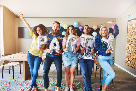 Happy group holding PARTY letters