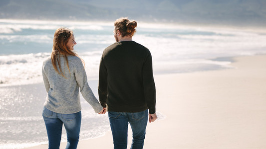 Romantic couple walking on the beach