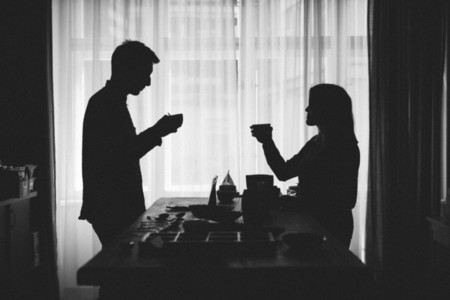 Silhouettes of couple drinking