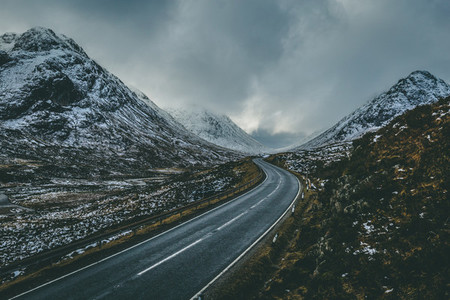 Open road winter snow mountain landscape in Glencoe Scotland