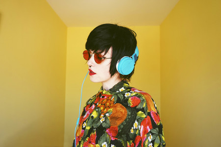 Cool androgynous dj woman in vibrant colors