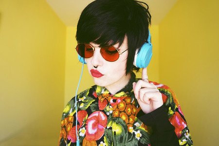 Cool androgynous dj woman in vibrant colors